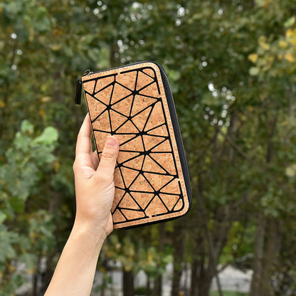 Eco-friendly Cork Grain Multifunctional Fashion Waterproof 3 Fold Hand Wallet held against a blurred outdoor background.