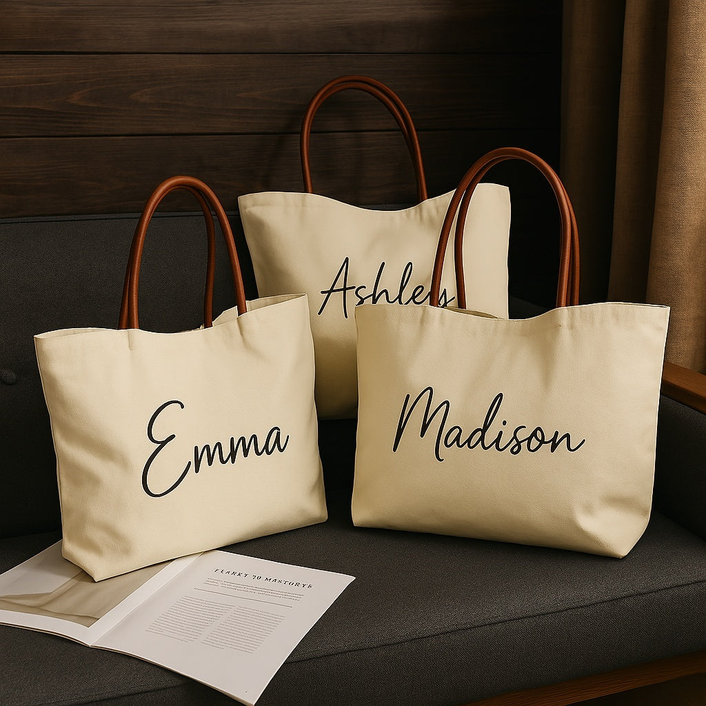 Three stylish Canvas Tote Bags with personalized names resting on a couch.